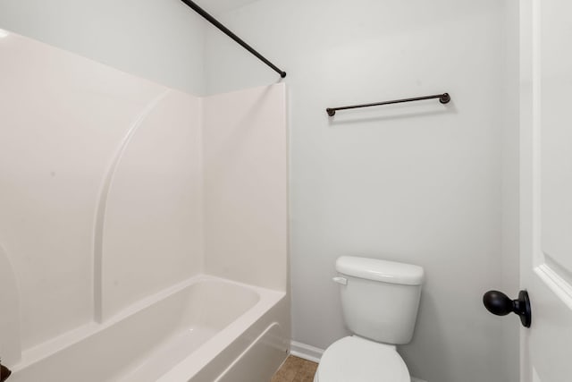 bathroom with tub / shower combination and toilet