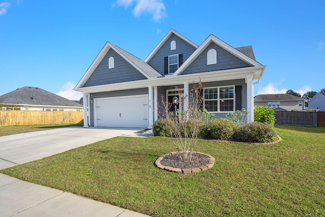 craftsman inspired home with a garage and a front lawn