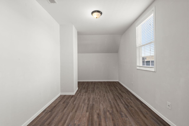 additional living space with dark hardwood / wood-style floors and lofted ceiling