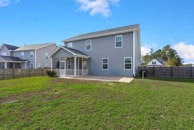 back of property featuring a patio area, a sunroom, and a lawn