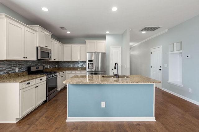 kitchen featuring white cabinetry, appliances with stainless steel finishes, and a center island with sink