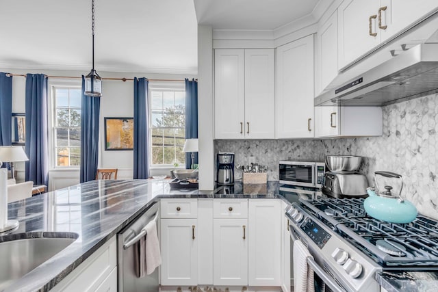 kitchen with white cabinets, pendant lighting, appliances with stainless steel finishes, and tasteful backsplash