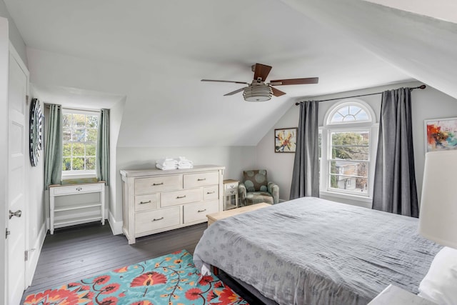 bedroom featuring dark hardwood / wood-style floors, vaulted ceiling, and ceiling fan