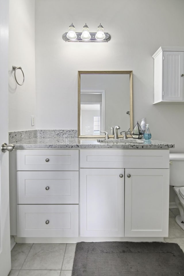 bathroom featuring toilet, tile patterned flooring, and vanity