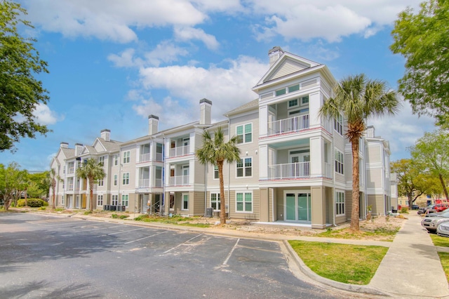 view of building exterior featuring uncovered parking