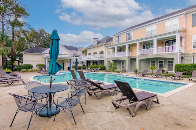 community pool with a patio area