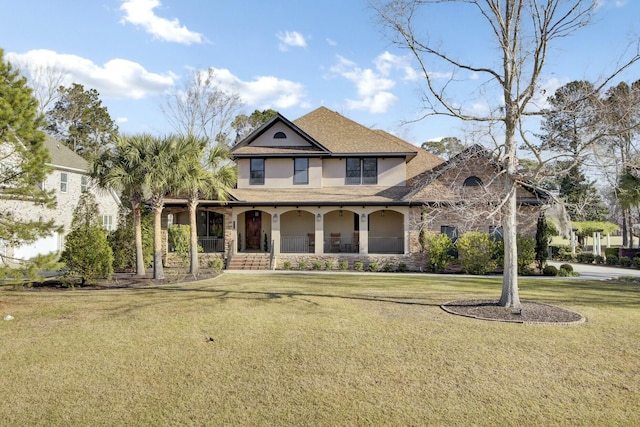 view of front facade with stone siding, covered porch, and a front yard