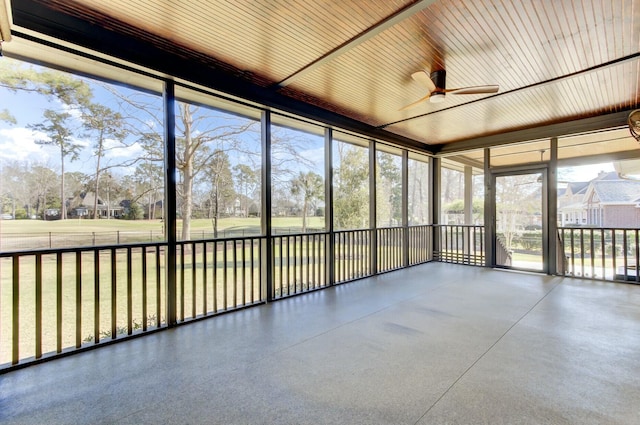 unfurnished sunroom with ceiling fan