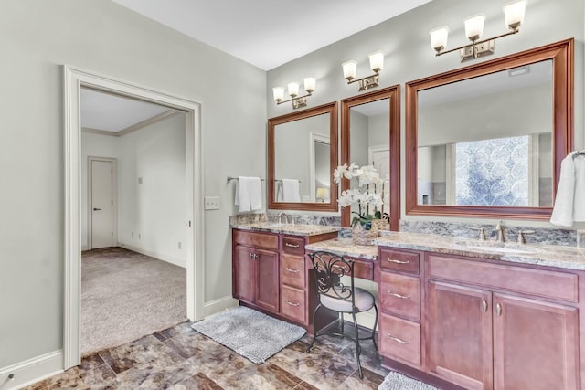 full bath with double vanity, baseboards, and a sink