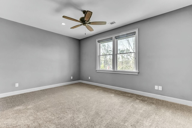 empty room featuring visible vents, baseboards, ceiling fan, and carpet flooring