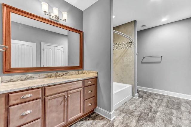 bathroom featuring vanity, bathing tub / shower combination, baseboards, and visible vents