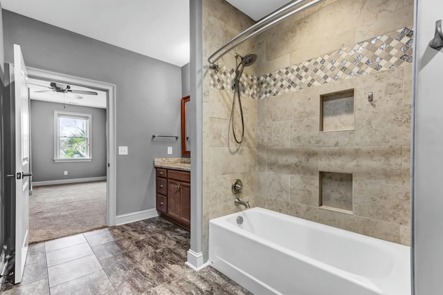 bathroom with ceiling fan, vanity, shower / tub combination, and baseboards