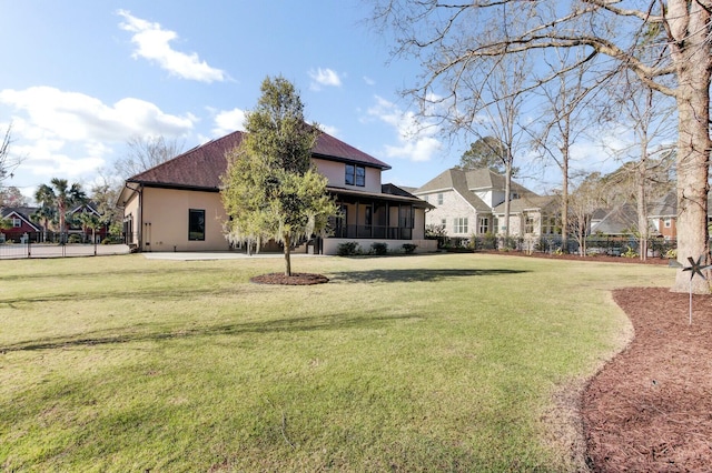 view of yard with fence and a sunroom