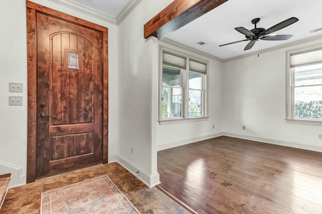 entryway with visible vents, ornamental molding, wood finished floors, baseboards, and ceiling fan