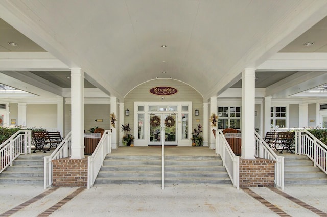 doorway to property featuring a porch and french doors