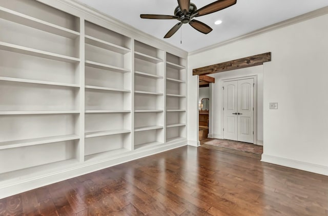 spare room with wood finished floors, crown molding, a ceiling fan, and baseboards