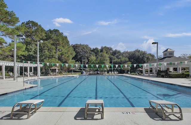 pool with a pergola and a diving board