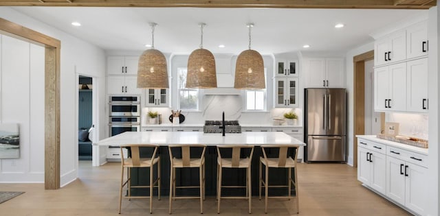 148 Falaise St, Charleston, SC 29492 - kitchen featuring appliances with stainless steel finishes, recessed lighting, light countertops, light wood finished floors, and decorative backsplash