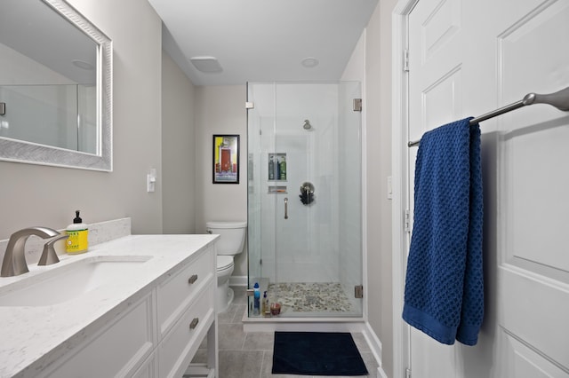 bathroom with tile patterned flooring, vanity, toilet, and a shower with shower door