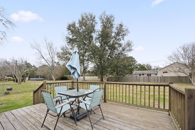 wooden deck featuring a lawn