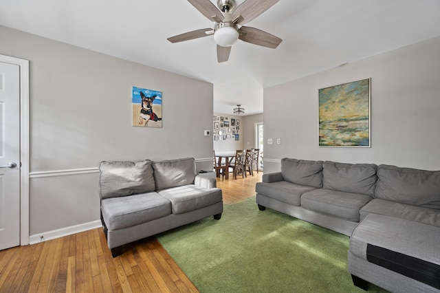 living room featuring hardwood / wood-style floors and ceiling fan