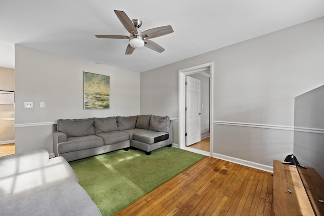 living room with wood-type flooring and ceiling fan