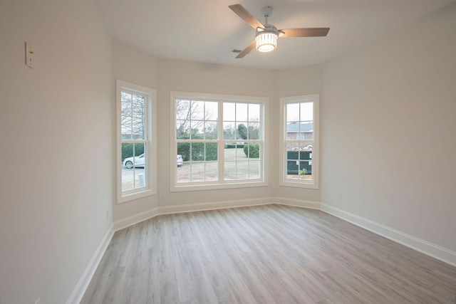 empty room with light hardwood / wood-style floors and ceiling fan