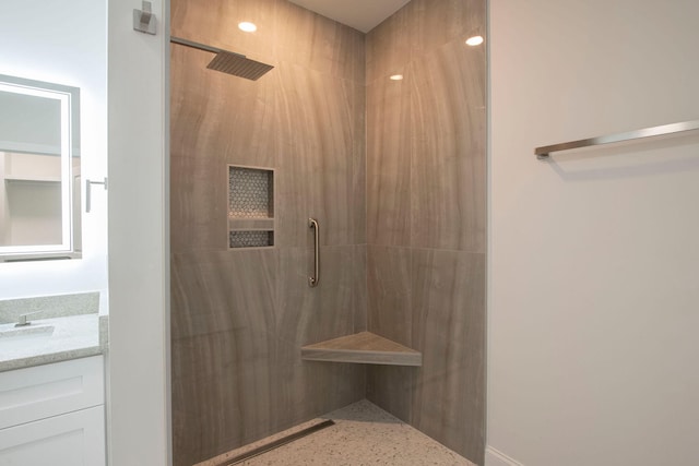 bathroom featuring vanity and a shower with shower door