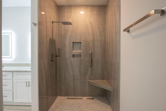 bathroom with vanity, a shower with shower door, and wood-type flooring