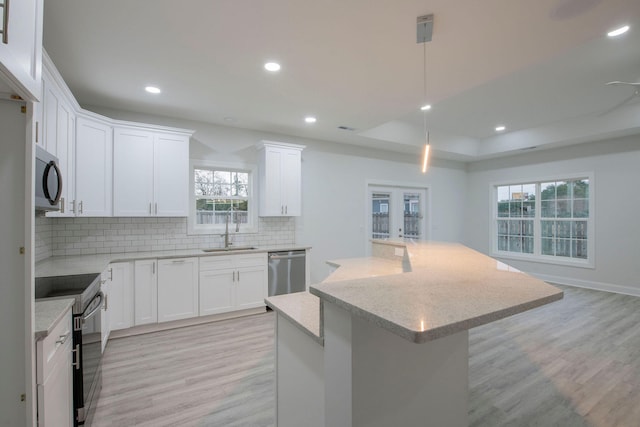 kitchen featuring sink, white cabinetry, light hardwood / wood-style flooring, and stainless steel appliances