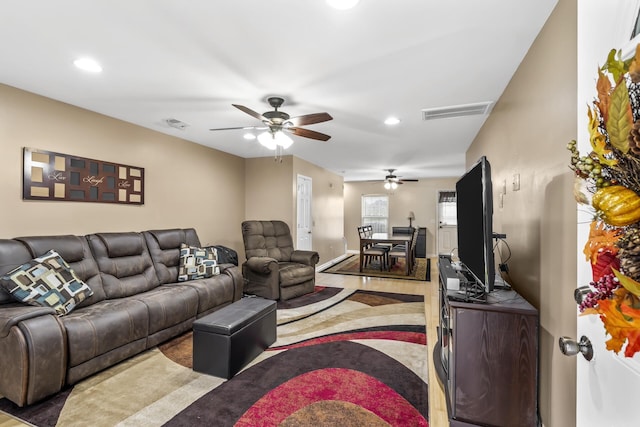 living room with hardwood / wood-style flooring and ceiling fan