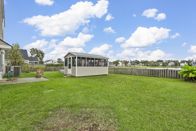 view of yard featuring cooling unit, a patio, and a sunroom