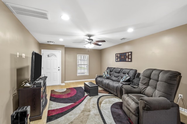 living room featuring light hardwood / wood-style flooring and ceiling fan