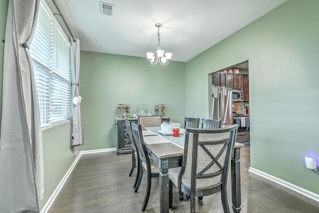 9101 Parlor Dr, Ladson, SC 29456 - dining area featuring a chandelier and dark wood-style flooring