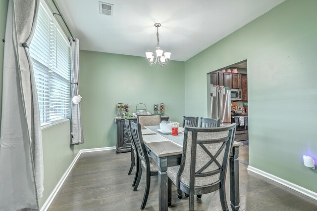 9101 Parlor Dr, Ladson, SC 29456 - dining space featuring a chandelier and dark wood-style flooring