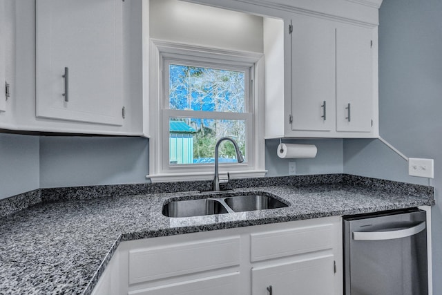 kitchen with dishwasher, white cabinetry, and a sink