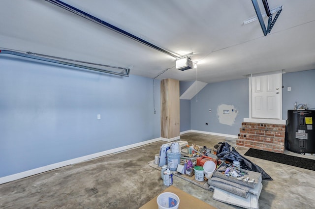 additional living space with water heater, concrete floors, and baseboards