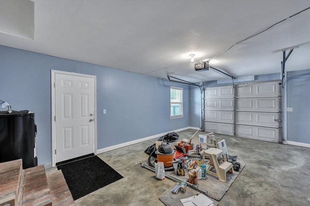 garage with baseboards, water heater, and a garage door opener