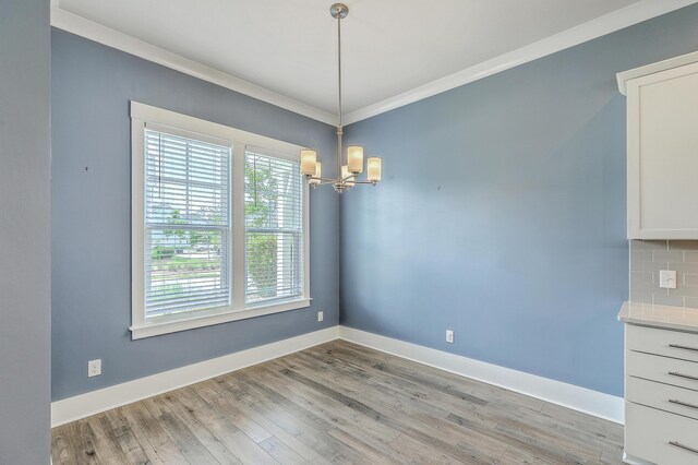 3125 Sturbridge Rd, Mount Pleasant, SC 29466 - unfurnished dining area featuring a chandelier, light wood-type flooring, baseboards, and ornamental molding