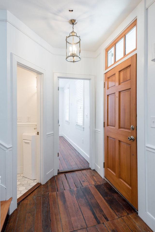 foyer featuring a notable chandelier and dark hardwood / wood-style floors