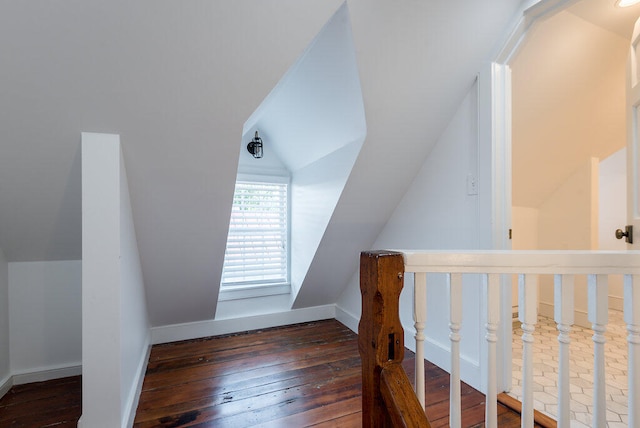 additional living space with lofted ceiling and dark hardwood / wood-style flooring