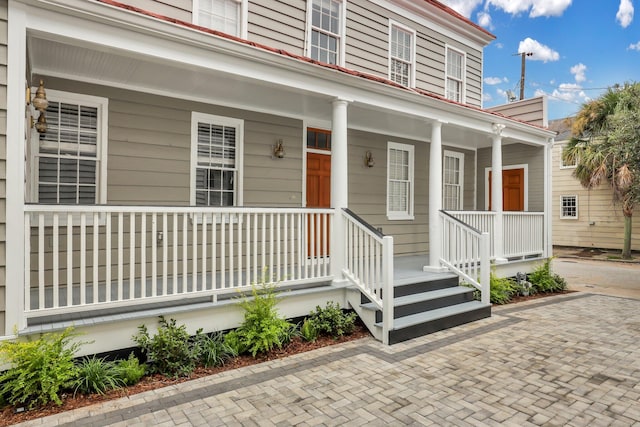 view of exterior entry with a porch