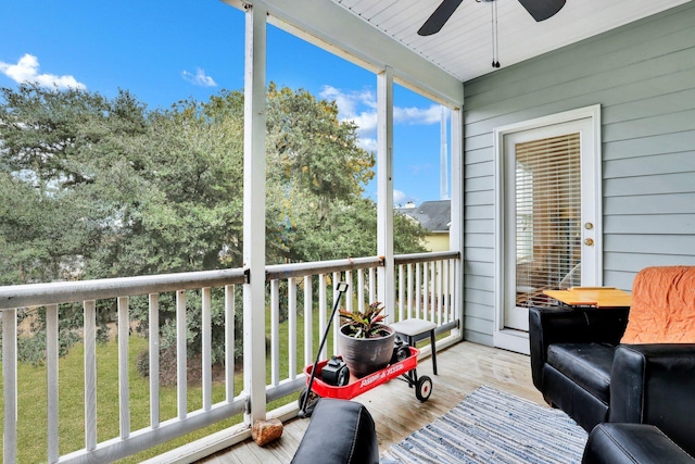 sunroom / solarium featuring ceiling fan