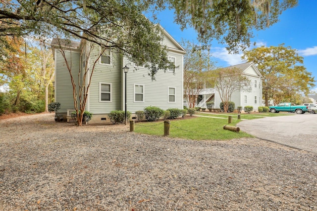 view of side of property with a lawn