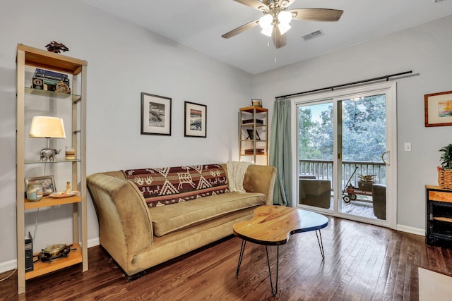 living room featuring ceiling fan and dark hardwood / wood-style flooring