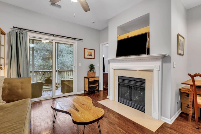 living room featuring dark hardwood / wood-style floors and ceiling fan