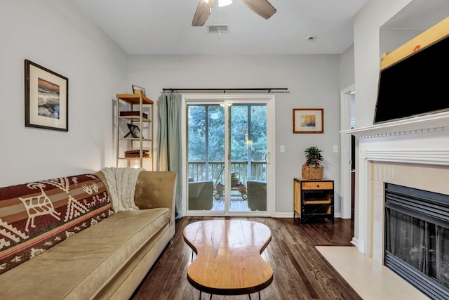 living room with ceiling fan and dark hardwood / wood-style floors