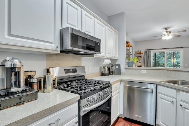 kitchen featuring ceiling fan, sink, white cabinets, and appliances with stainless steel finishes