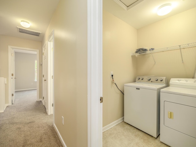 laundry area with visible vents, baseboards, laundry area, independent washer and dryer, and light colored carpet