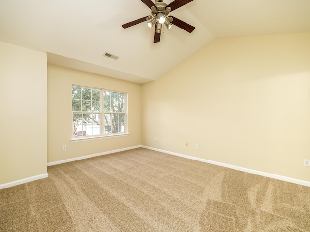 unfurnished room with baseboards, vaulted ceiling, carpet floors, visible vents, and ceiling fan